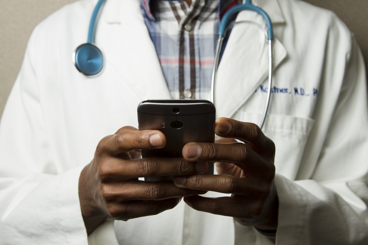 Doctor reviewing compliance data on tablet
